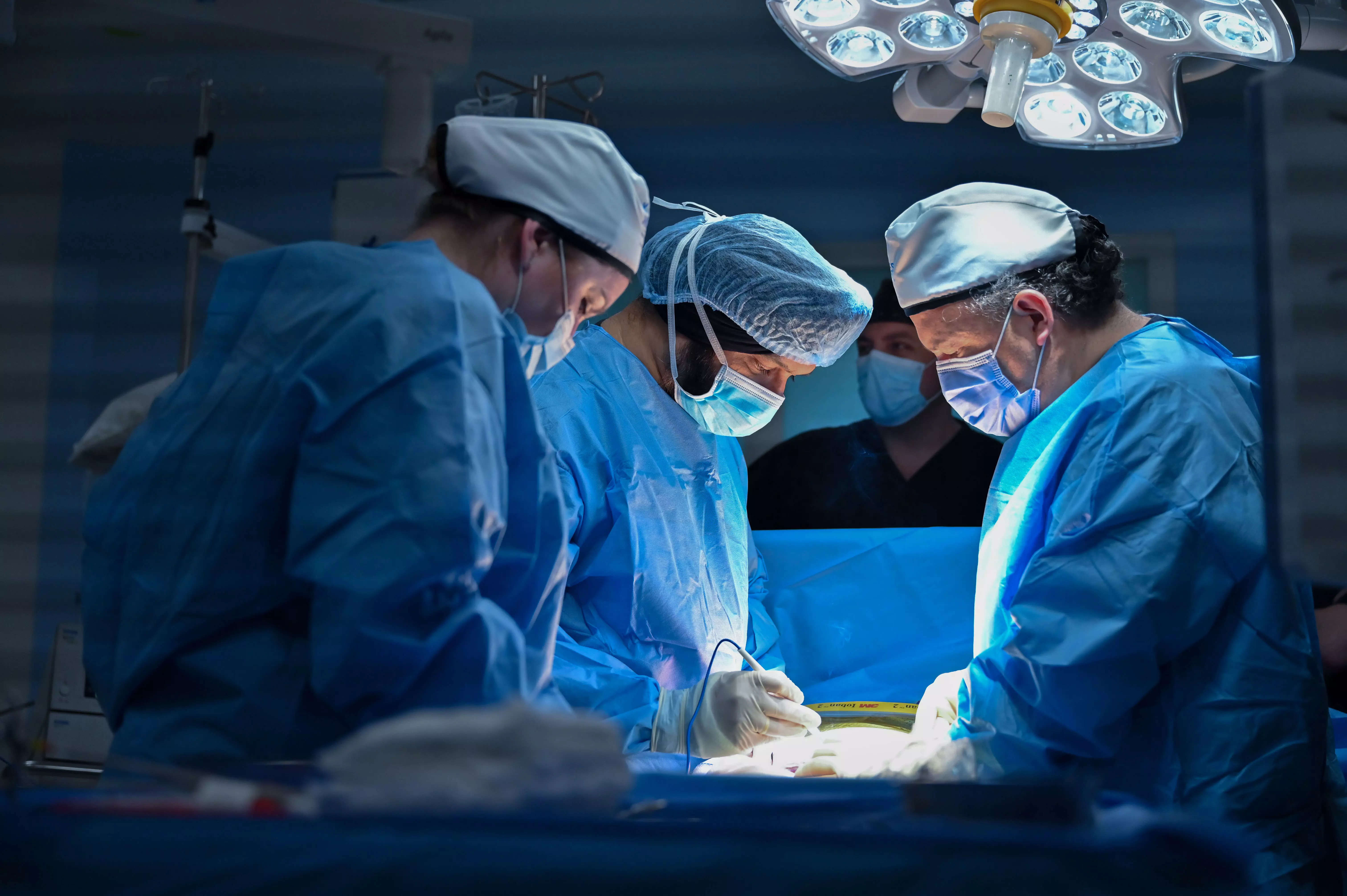 <p>Dr Singh with his team performing the procedure.</p>