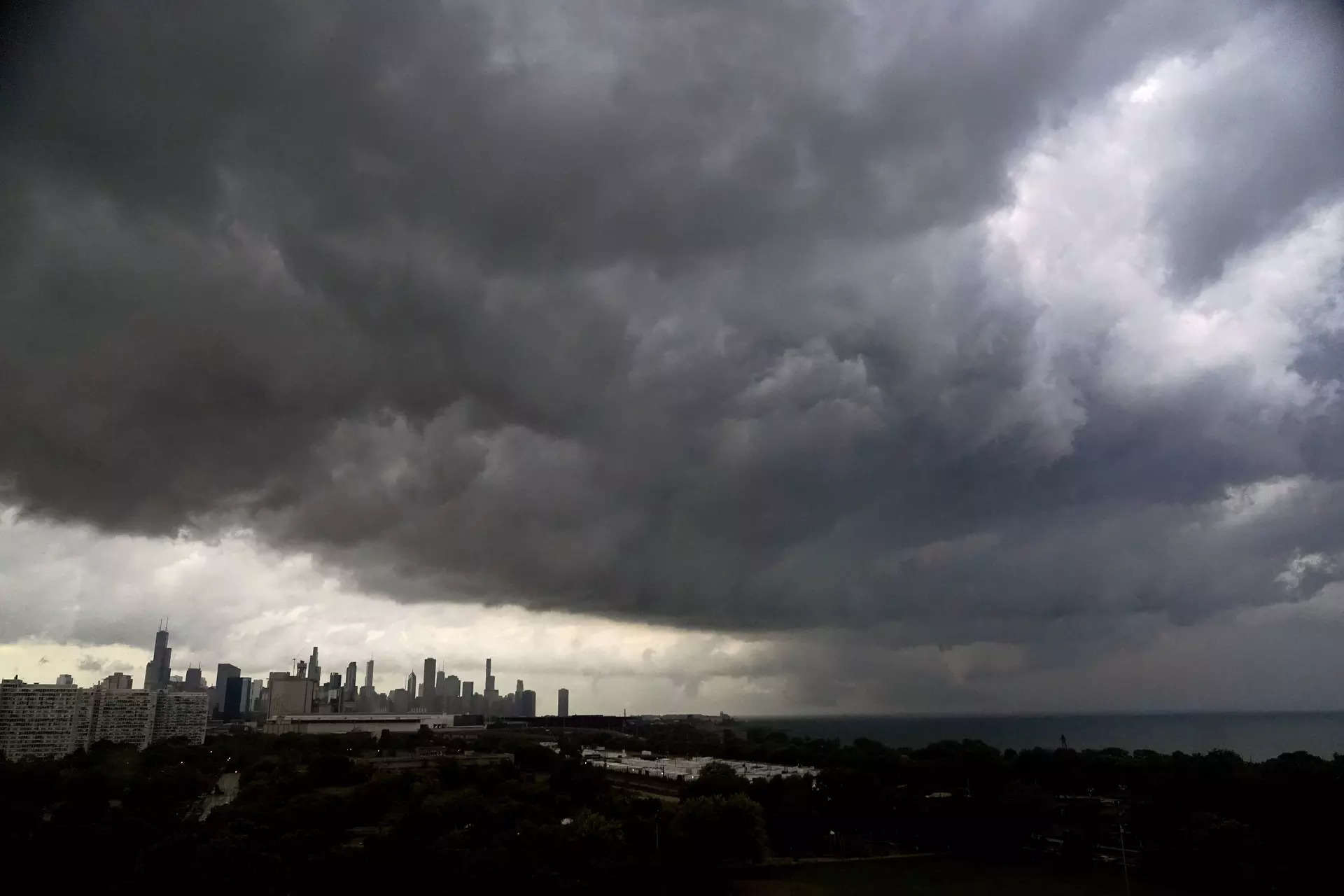 <p>Storm clouds pass over downtown Chicago and the Bronzeville neighborhood of the city heading East out over Lake Michigan as the National Weather Service continued to issue multiple tornado warnings in the greater metropolitan area Wednesday, July 12, 2023. (AP Photo/Charles Rex Arbogast)</p>