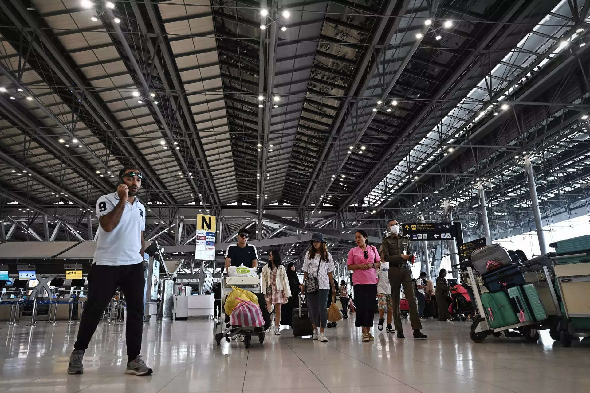 <p>Travelers navigate the departures terminal at Suvarnabhumi International Airport in Bangkok on August 7, 2023.</p>