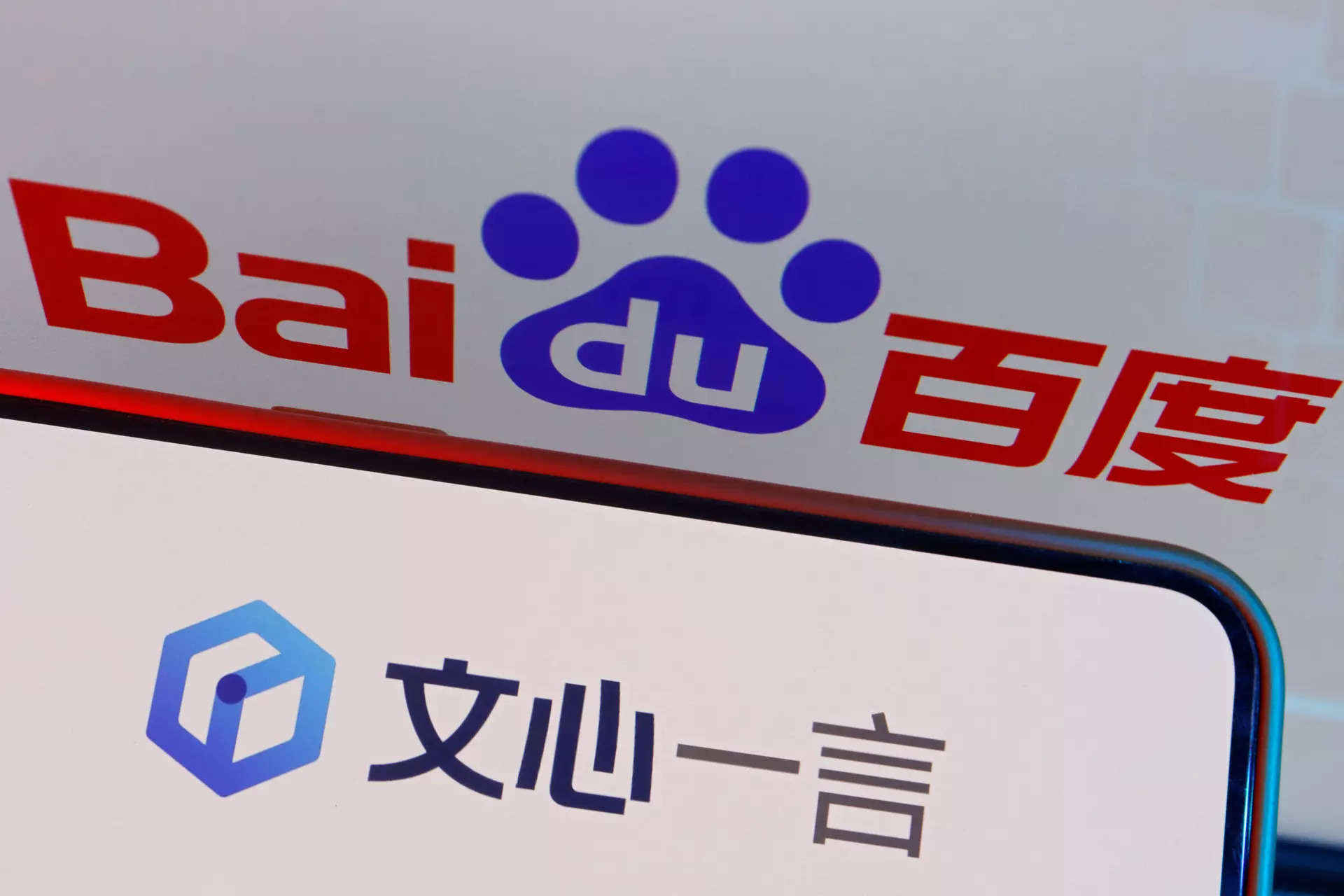 <p>The logo of Baidu's AI chatbot Ernie Bot is displayed near a screen showing the Baidu logo, in this illustration picture </p>