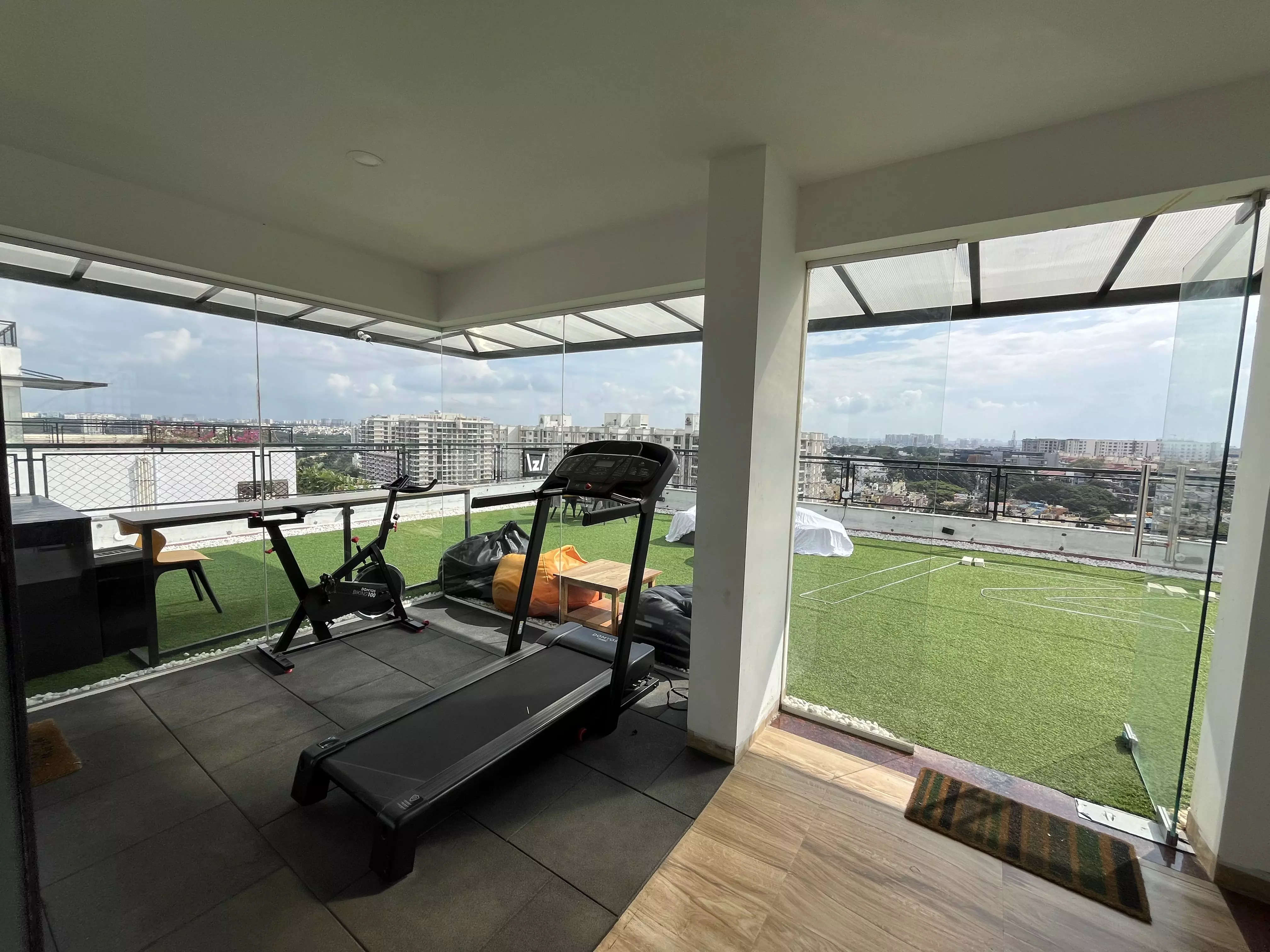 <p>A gym overlooking the terrace at the Zo House</p>