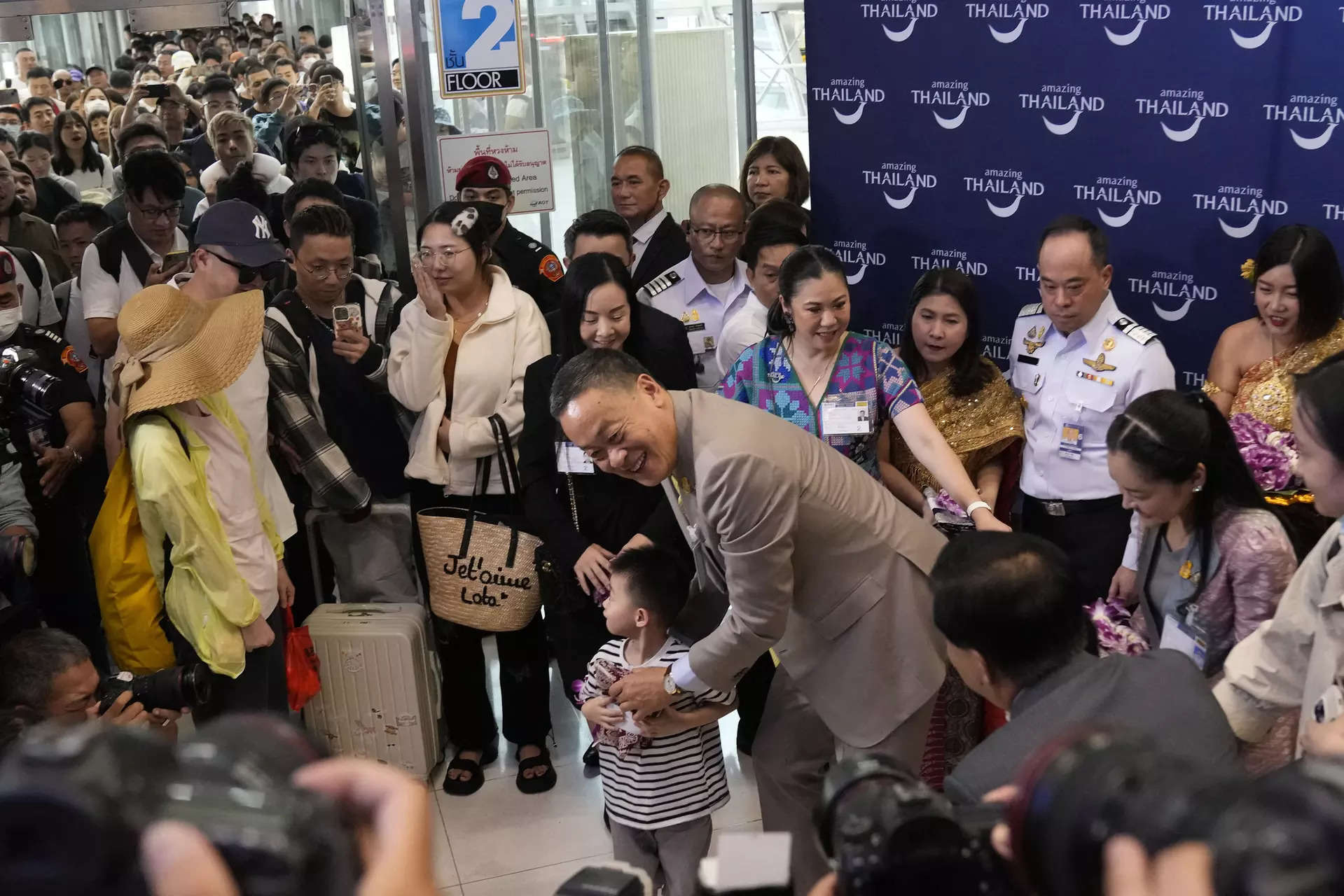 <p>FILE - Chinese boy tourists are welcomed by Thailand's Prime Minister Srettha Thavisin, right, on their arrivals at Suvarnabhumi International Airport in Samut Prakarn province, Thailand, Monday, Sept. 25, 2023. Thailand and China will soon implement visa-free entry for each other’s citizens, Thai Prime Minister Srettha Thavisin said Tuesday, Jan. 2, 2024.(AP Photo/Sakchai Lalit, File)</p>