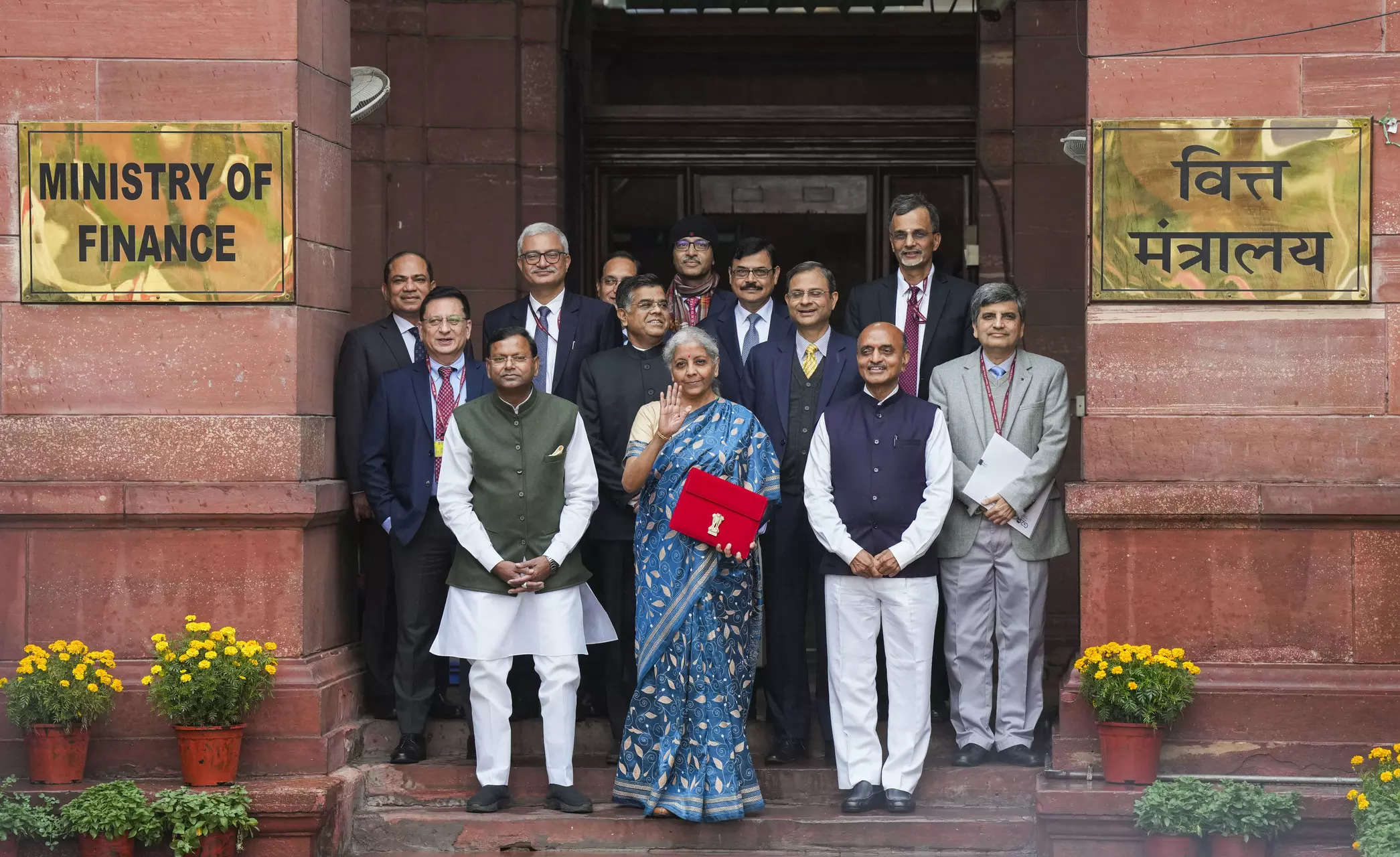 <p>Union Finance Minister Nirmala Sitharaman with Ministers of State Bhagwat Kishanrao Karad and Pankaj Chaudhary, and other officials poses for photos outside the Finance Ministry, holding a folder-case containing the Interim Budget 2024, in New Delhi. (PTI Photo/ Manvender Vashist Lav)(</p>