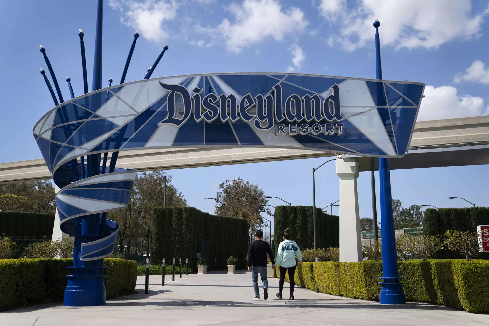 <p>FILE - Two visitors enter Disneyland Resort in Anaheim, California.</p>