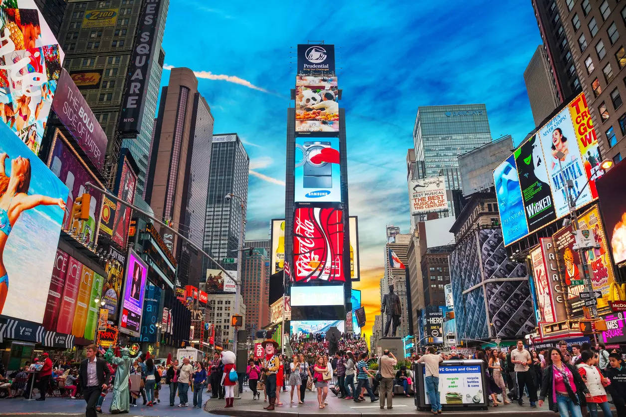 <p>Times Square with tourists. Iconified as "The Crossroads of the World" it's the brightly illuminated hub of the Broadway Theater District.</p>
