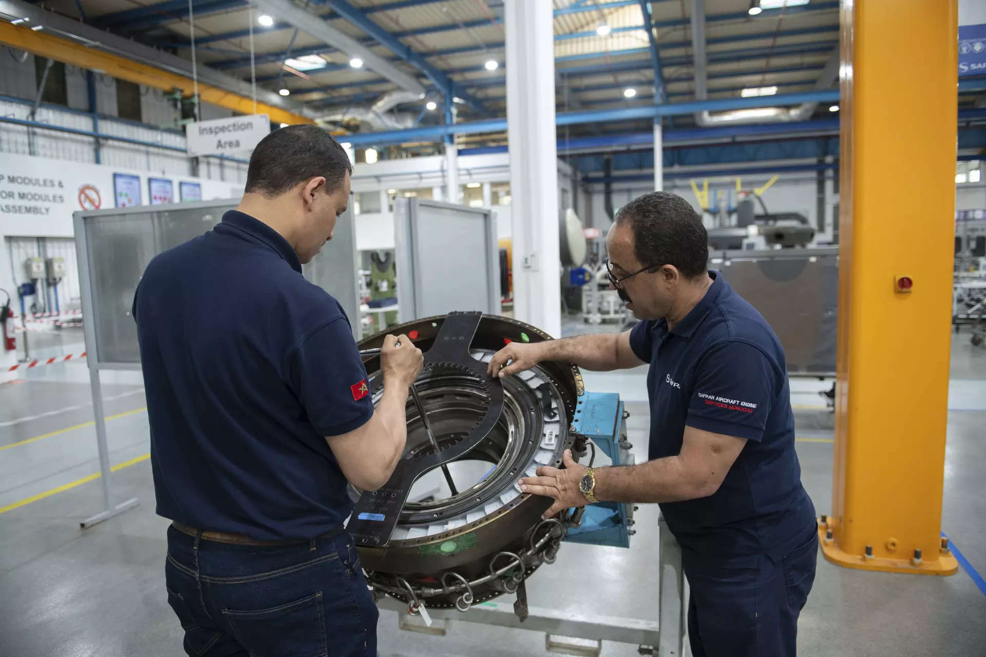 <p>Engineers and workers repair an aircraft part inside Safran Aircraft Engines repair plant outside of Casablanca, Morocco.</p>