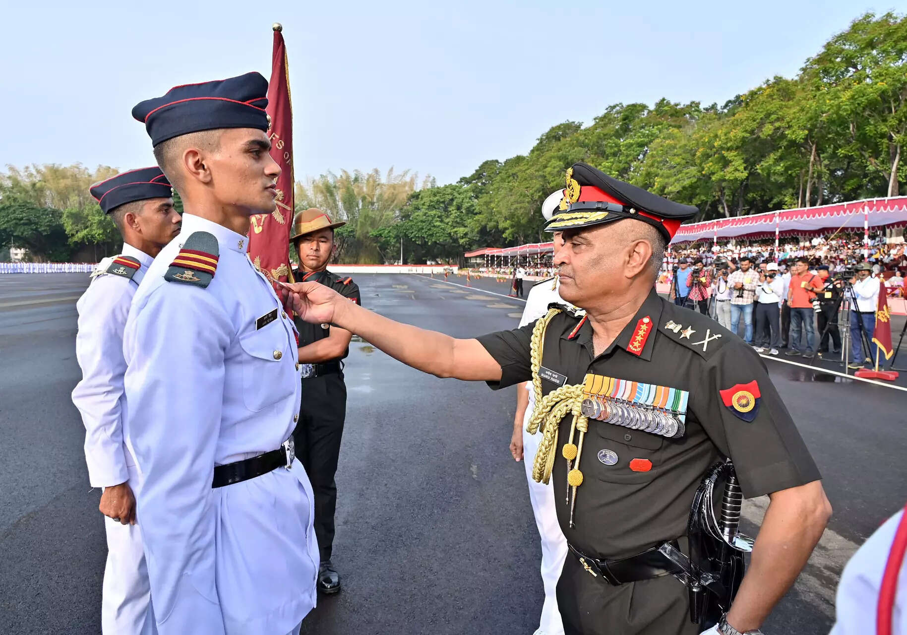 <p>Chief of Army Staff General Manoj Pande pins a medal on a cadet during the Passing Out Parade of the 146th NDA Course, at Khetarpal Parade Ground in New Delhi on Friday. (ANI Photo)</p>
