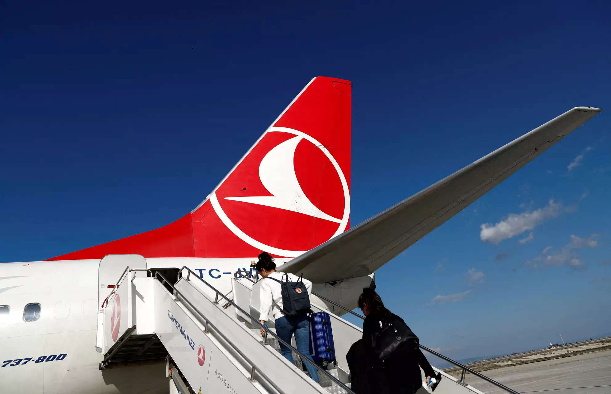 <p>FILE PHOTO: Passengers board on a Turkish Airlines (THY) Boeing 777-800 plane at Hatay Airport in Hatay, Turkey, March 1, 2020. Picture taken March, 1, 2020. REUTERS/Murad Sezer/File Photo</p>