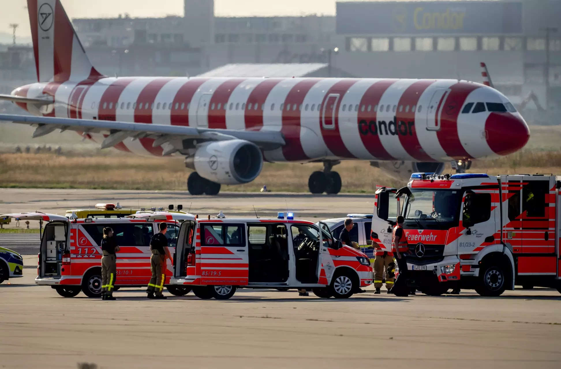 <p>Emergency vehicles stand on a runway at the airport in Frankfurt, Germany, after a few climate activists glued themselves to the ground blocking air traffic.</p>