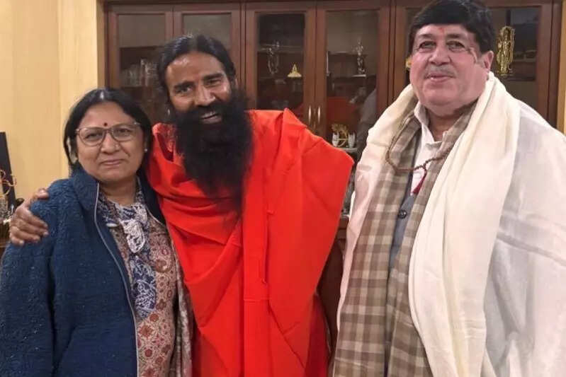 <p>Dileep Sanghani and wife Geeta Sanghani with Yoga guru Baba Ramdev at the Patanjali Yogpeeth in Haridwar</p>