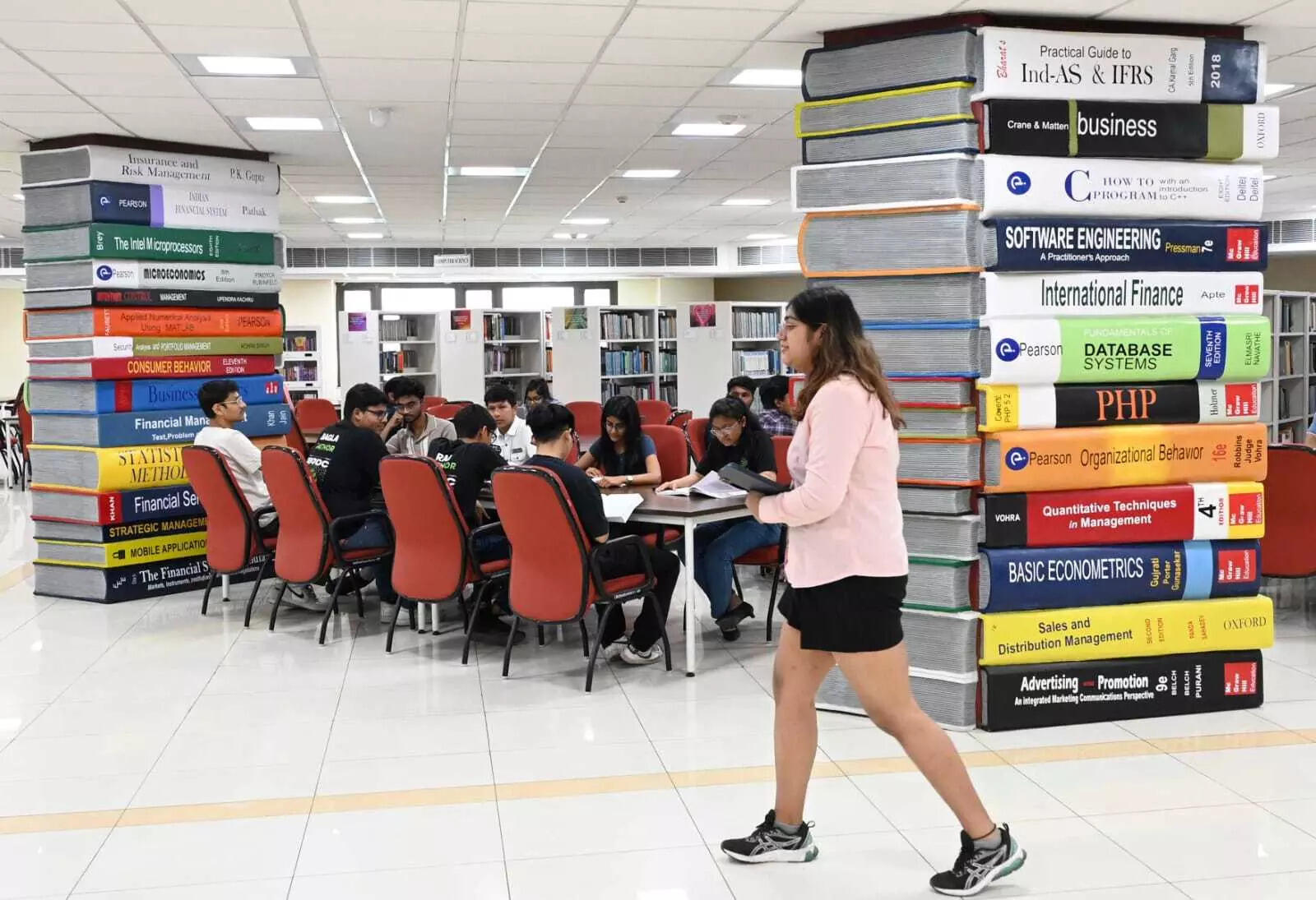 <p>The pillars in the college library are designed to resemble piles of books</p>