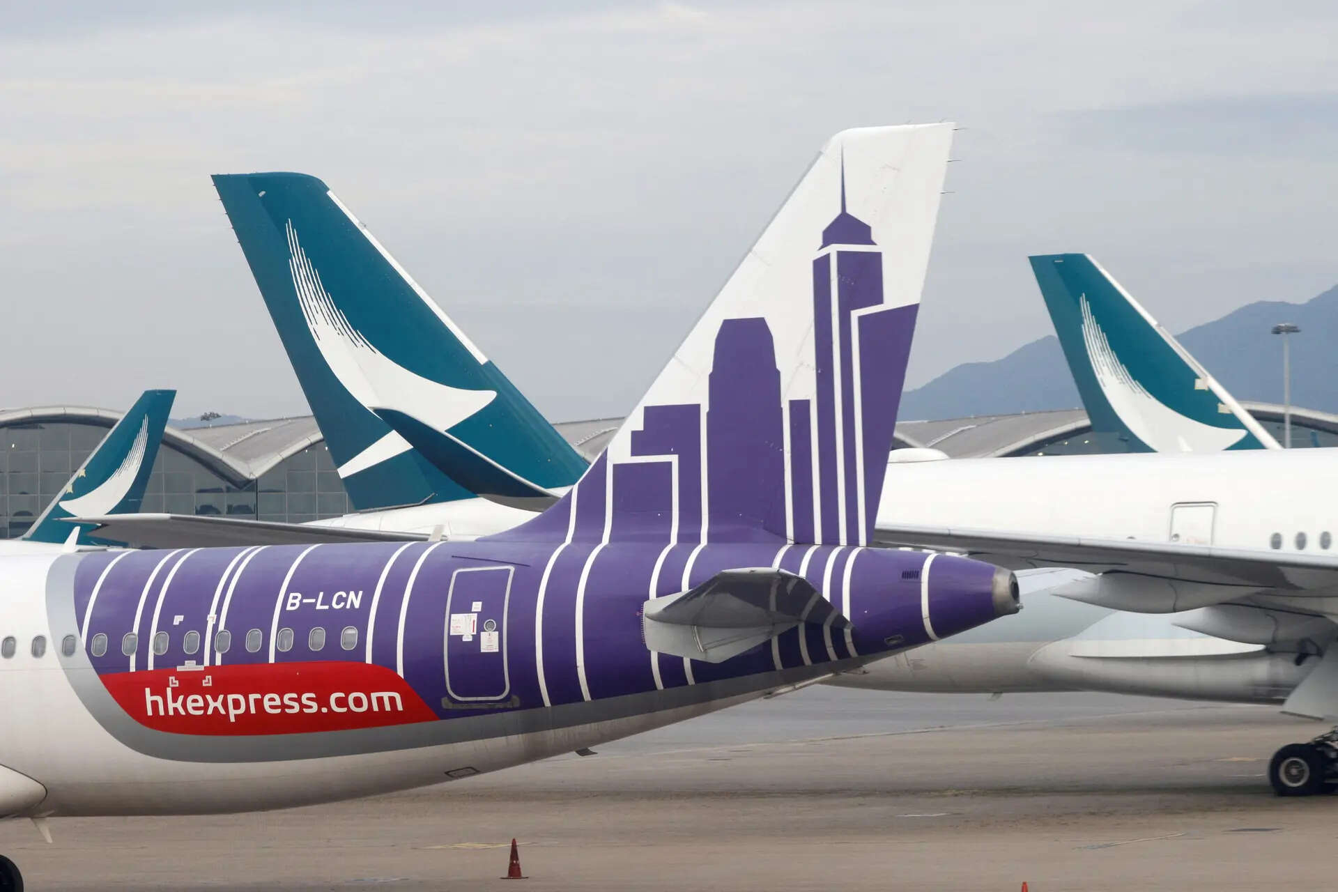 <p> Aircraft of Cathay Pacific and its budget airline HK Express are parked on the tarmac at the Hong Kong International Airport, Hong Kong.</p>
