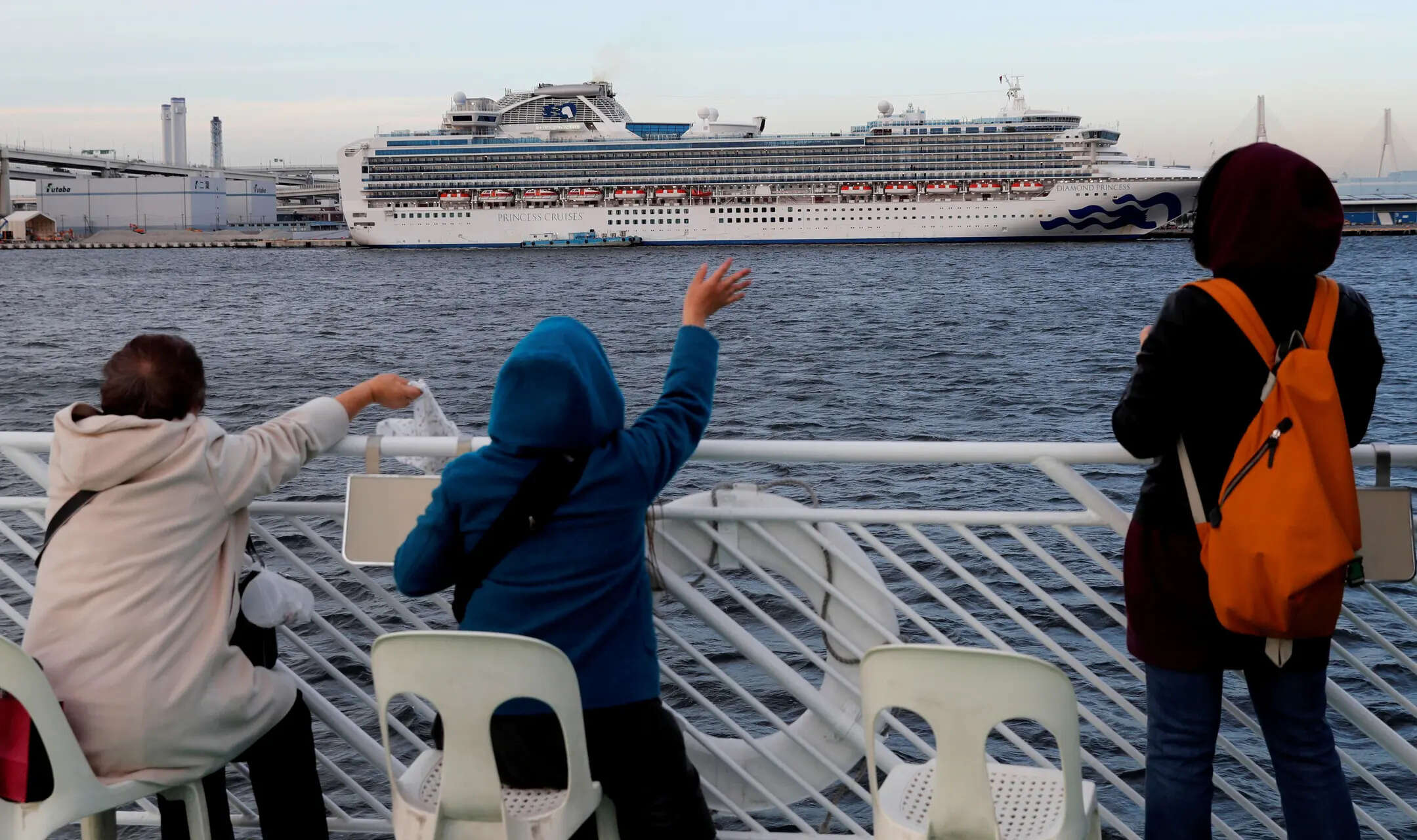 

<p>Tourists on a sightseeing cruise ship wave to passengers of the cruise ship Diamond Princess, which is anchored at Daikoku Pier Cruise Terminal in Yokohama, south of Tokyo, Japan February 12, 2020. </p>
<p>“/><figcaption class=