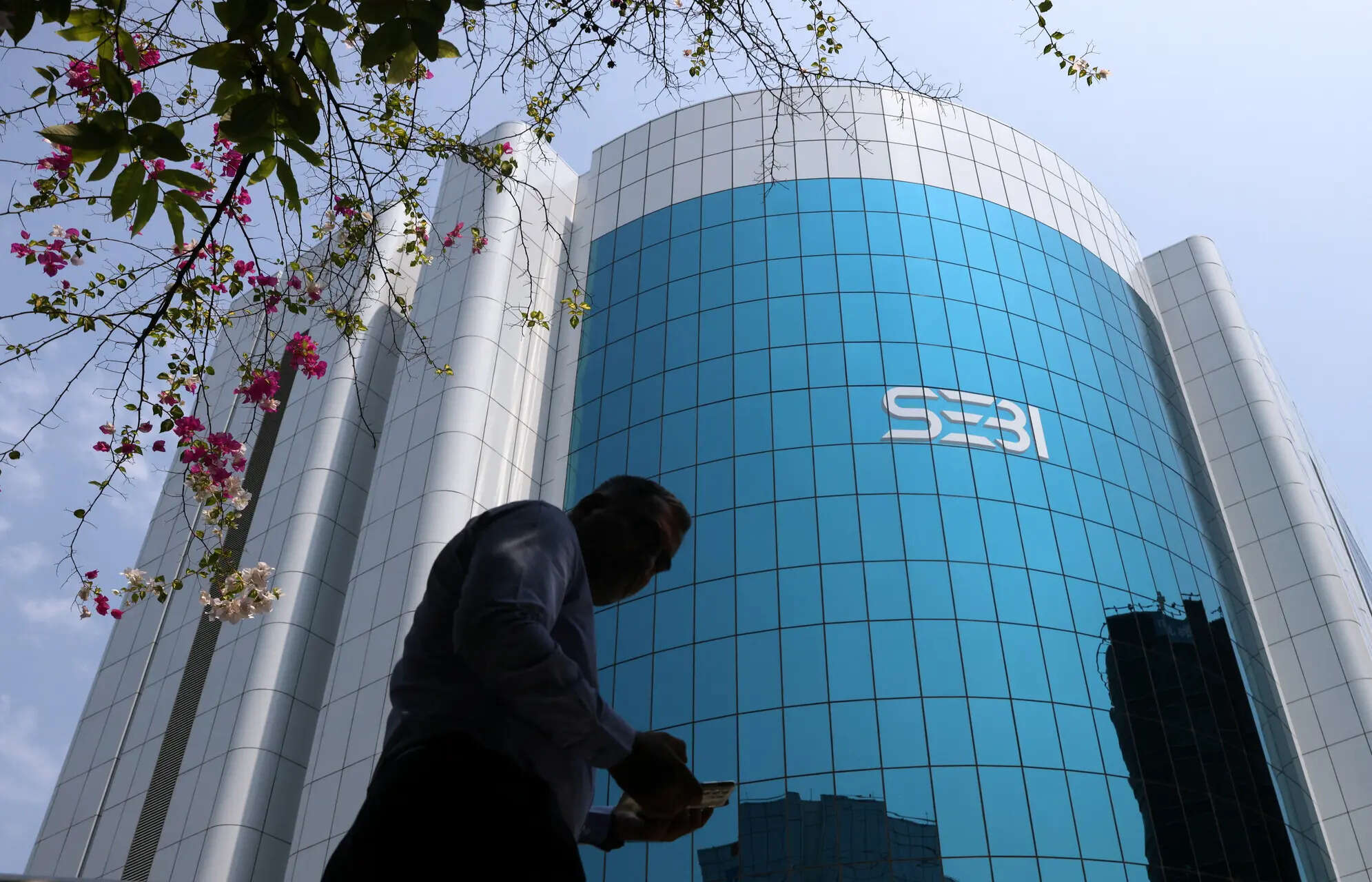 A man walks past the Securities and Exchange Board of India (SEBI) headquarters in Mumbai, India, April 19, 2023. REUTERS/Francis Mascarenhas/File Photo