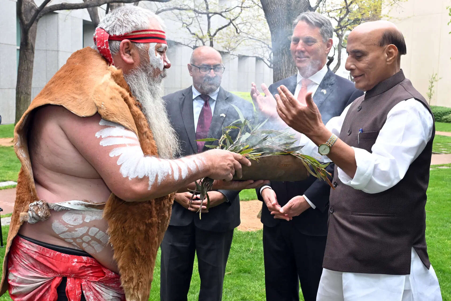 India's Defence Minister Rajnath Singh, right, participates in an indigenous smoking ceremony with his Australian counterpart Richard Marles, second right, at Parliament House in Canberra, Australia. 