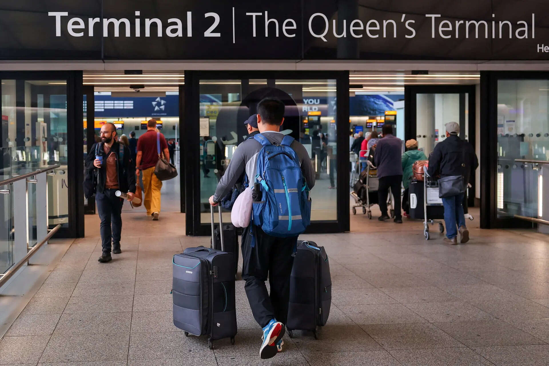 FILE PHOTO: A traveller arrives at Heathrow Airport Terminal 2, amid flight delays and cancellations, resulting from a disruption to check-in and boarding systems caused by a cyberattack which has affected several major European airports, in Greater London, Britain, September 20, 2025. REUTERS/Isabel Infantes/File Photo