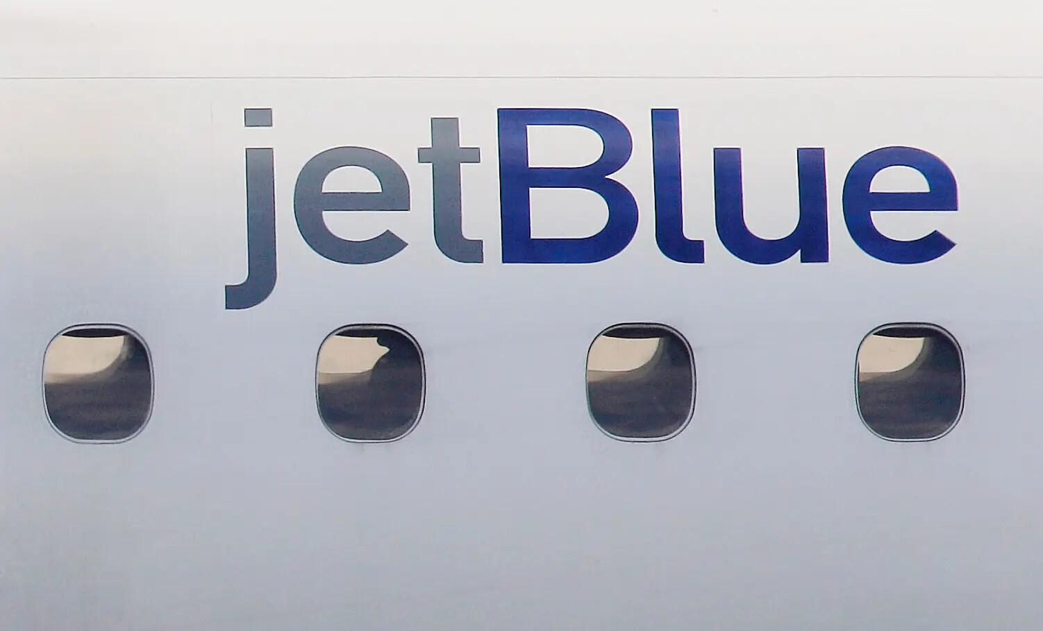 <p>FILE - A JetBlue logo is displayed on the side of a jet as it taxis at Boston's Logan International Airport, Jan. 20, 2011. </p>