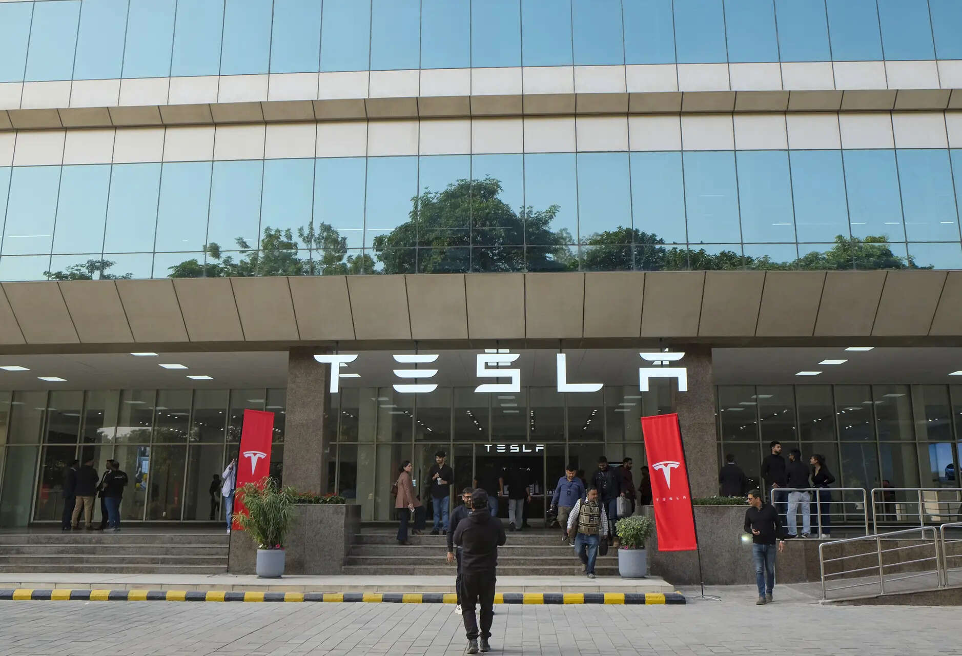 Teslas sluggish start marks a sharp contrast between its initial ambitious plans for India, including building a car plant, and its current spot on the sidelines of this expanding EV market.