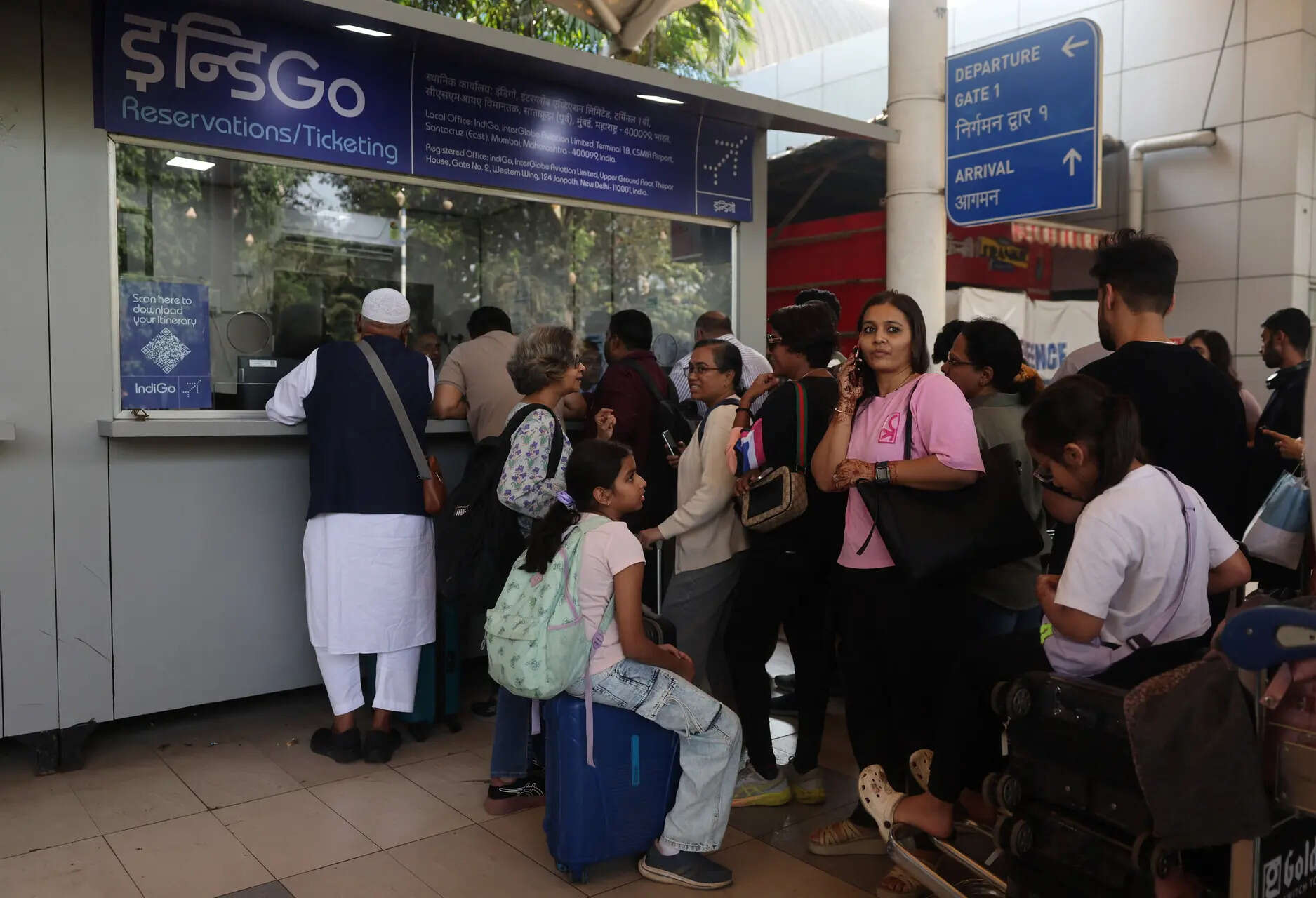 <p>Passengers wait outside the IndiGo airlines ticket counter after several flights were cancelled at Mumbai Airport </p>