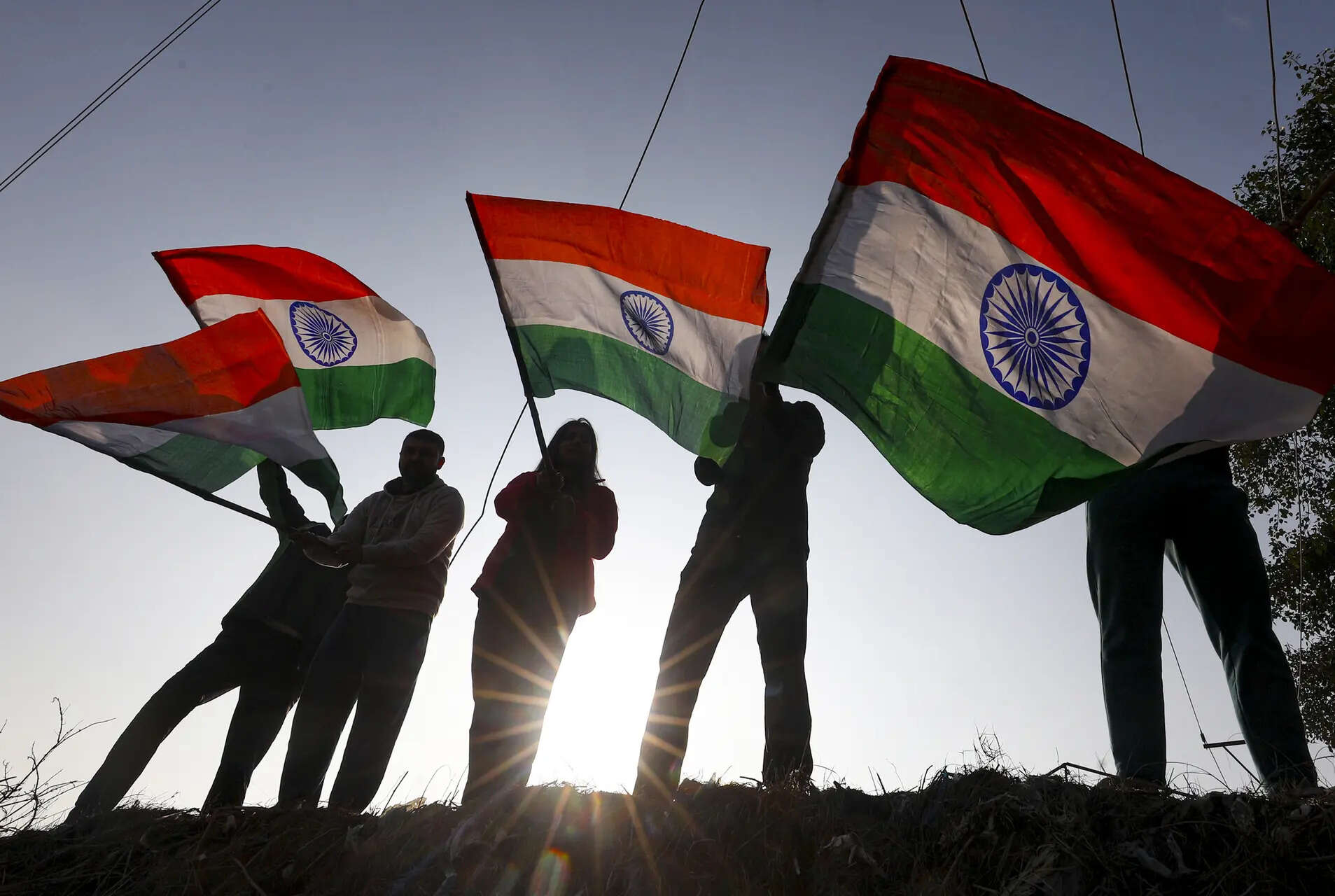 Youngsters wave the tricolour ahead of Republic Day 2026 celebrations, in Jammu. 