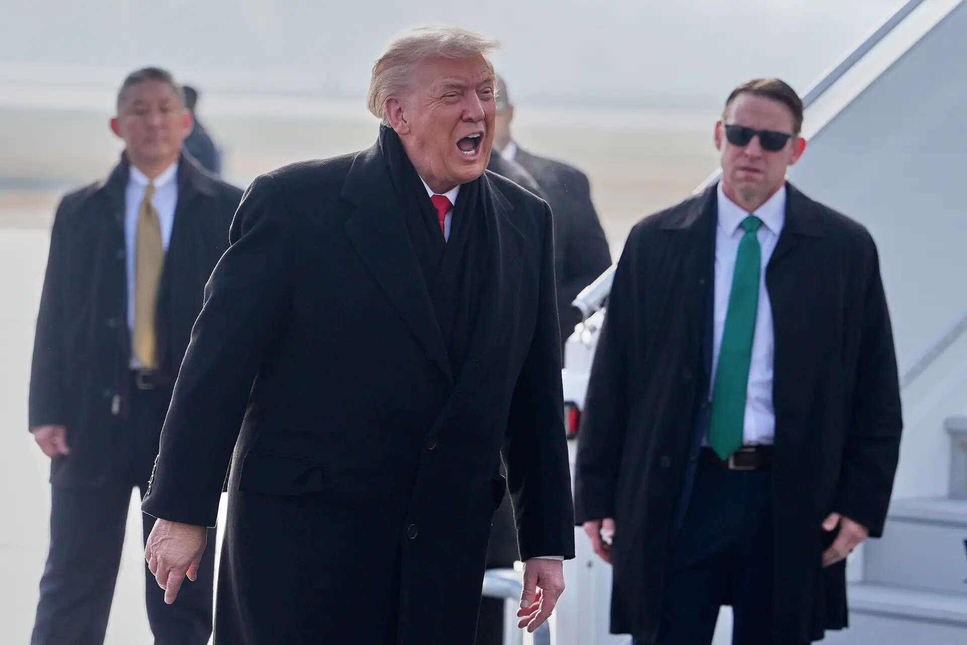 President Donald Trump, center, speaks as he steps off Air Force One after arriving at Zurich International Airport for the World Economic Forum