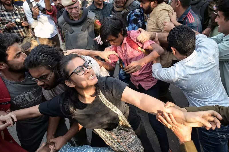 University security personnel moved along with the students, forming a human chain ahead of them as the procession made its way to the gate. Outside the campus, heavy police deployment had already been made. 