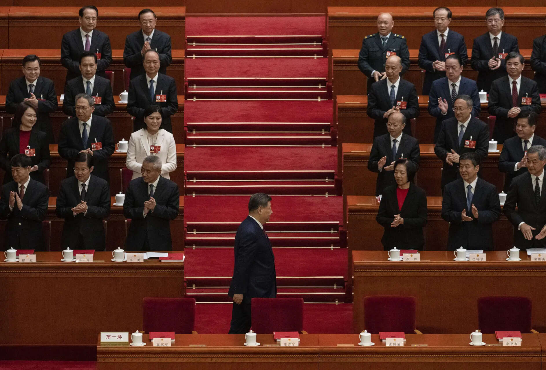 Chinese President Xi Jinping, centre, is applauded by senior members of the government as he arrives at the closing session of the National People's Congress at the Great Hall of the People on March 12, 2026 in Beijing, China. 