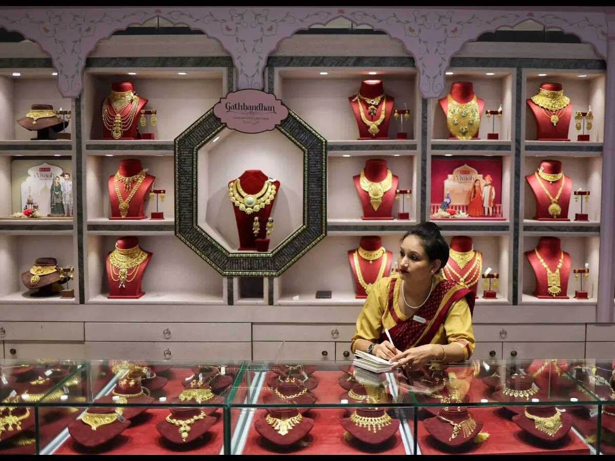 A saleswoman sits inside a Senco Gold & Diamonds jewellery showroom in Kolkata, India, January 28, 2026.