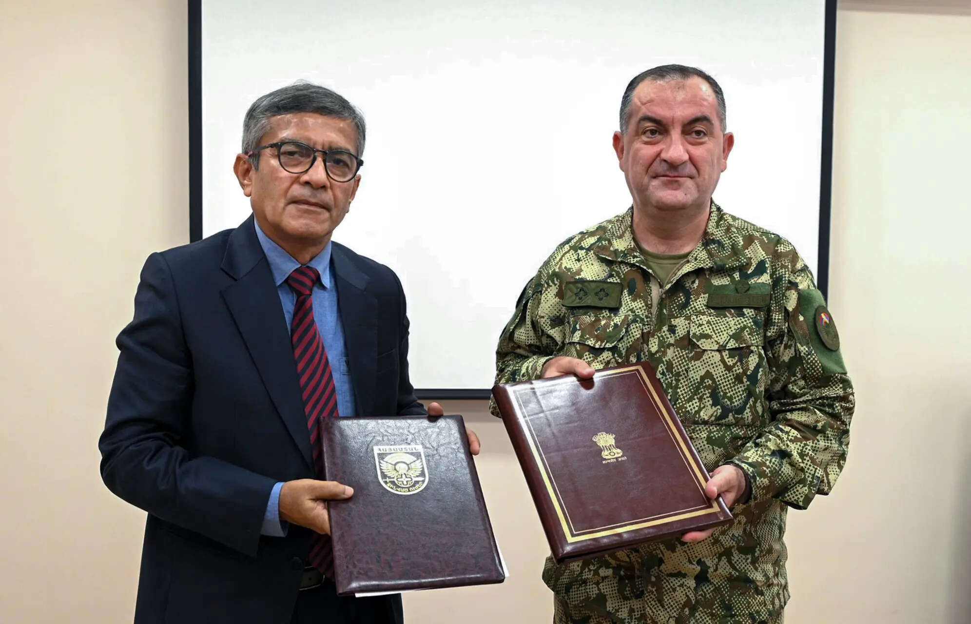 Defence Secretary Rajesh Kumar Singh and Chief of the General Staff of the Armed Forces of Armenia, Lieutenant General Edvard Asryan, display copies of a bilateral agreement document during their meeting in Yerevan.
