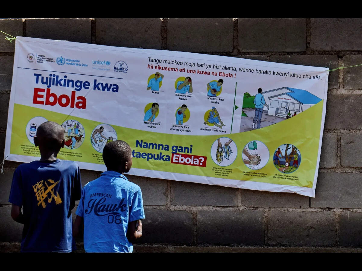 FILE PHOTO: Congolese children read an advocacy poster as aid agencies intensify efforts to contain a new Ebola outbreak involving the Bundibugyo strain outbreak, in Bunia, Ituri province, Democratic Republic of Congo, May 20, 2026. REUTERS/Gradel Muyisa Mumbere/File Photo