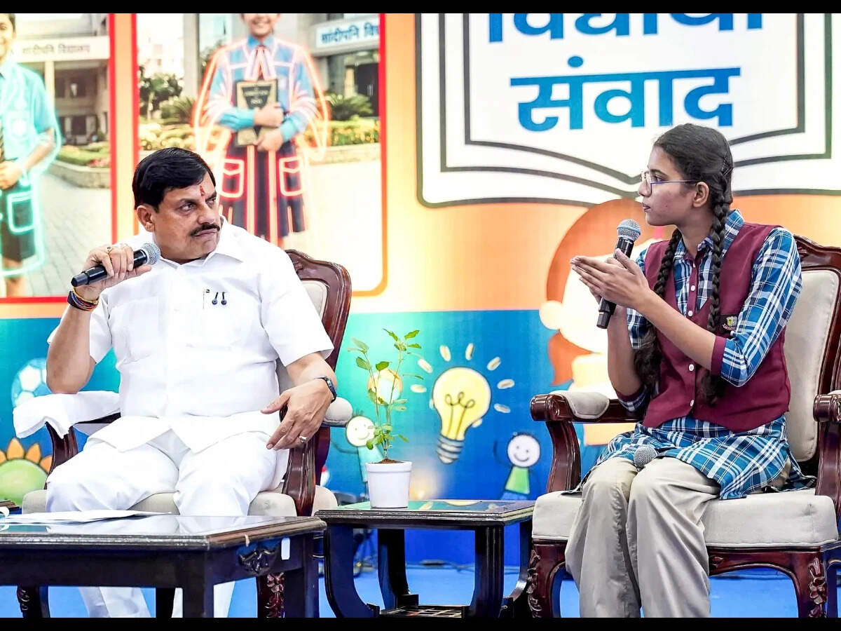 Madhya Pradesh Chief Minister Mohan Yadav with a student during an interaction programme 