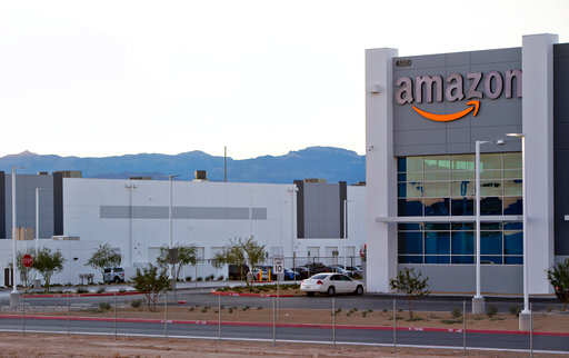 File - In this Tuesday, Dec. 5, 2017 file photo, an Amazon fulfillment center is shown in a commercial development near Interstate-15 and Tropical Parkway in North Las Vegas. Online retailer Amazon said Wednesday, April 4, 2018, it will build another warehouse packing and distribution center in the Las Vegas area. The facility should open next year on 800,000-square-feet of vacant land east of Interstate 15, not far from the Las Vegas Motor Speedway, the company and city of North Las Vegas said in statements. (File)