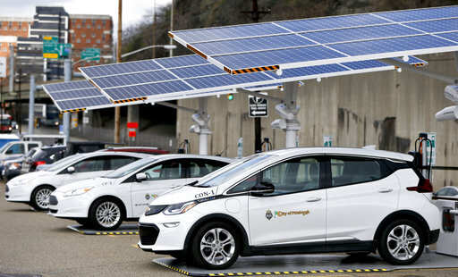 Some of the city of Pittsburgh's fleet of electrical vehicles are parked under solar charging panels before a news conference announcing the facility debut, Wednesday, April 18, 2018, in Pittsburgh. The press release from the city says that they currently have four electric vehicles and later this year they will receive six more cars that will be charged at these stations. According to the city, half of the $84,000 cost of each unit will be reimbursed through the State's Alternative Fuels Incentive Grant (AFIG).Photo/Keith Srakocic)