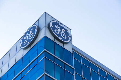 FILE- In this Jan. 16, 2018, file photo, the General Electric logo is displayed at the top of their Global Operations Center in the Banks development of downtown Cincinnati. General Electric reports earnings Friday, April 20, 2018.Photo/John Minchillo, File)
