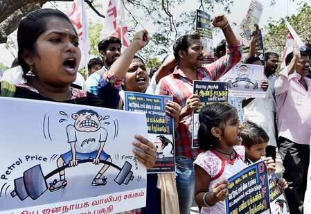 Protesters display placards and raise slogans during a protest against the Union Government over the hike of fuel prices.