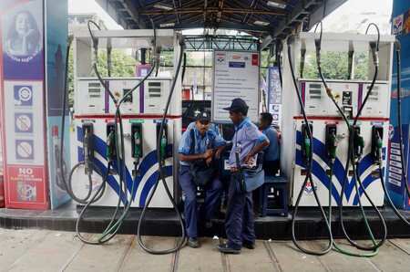Employees at a petrol Pump in Kolkata on Saturday, as the fuel prices remain at record high level.Photo