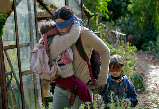 This image released by Netflix shows Sandra Bullock in a scene from &quot;Bird Box,&quot; a film which will have an exclusive run in theaters before becoming available on Netflix's streaming service. (Saeed Adyani/Netflix via AP)