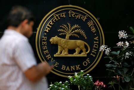 A man checks his phone outside the Reserve Bank of India (RBI) headquarters in Mumbai, India, April 5, 2018. REUTERS/Francis Mascarenhas/Files