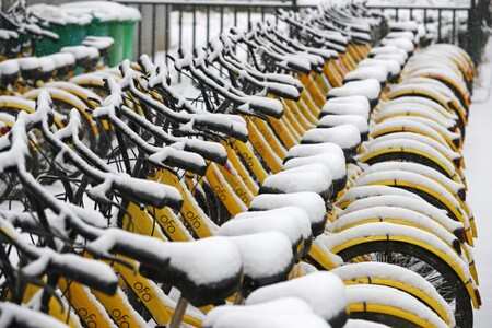 Ofo shared bicycles are seen covered with snow in Zhengzhou, Henan province, China January 4, 2018. REUTERS/Stringer