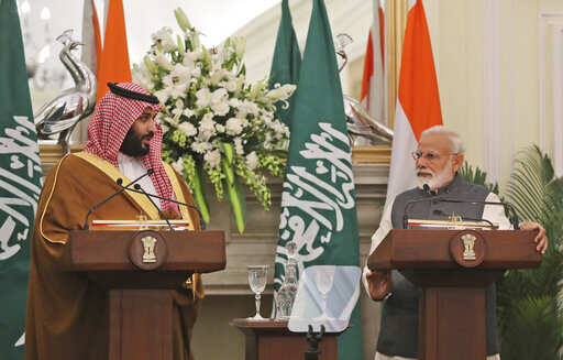 Saudi Crown Prince Mohammed bin Salman, left, makes a press statement watched by Indian prime minister Narendra Modi after their delegation level meeting 
