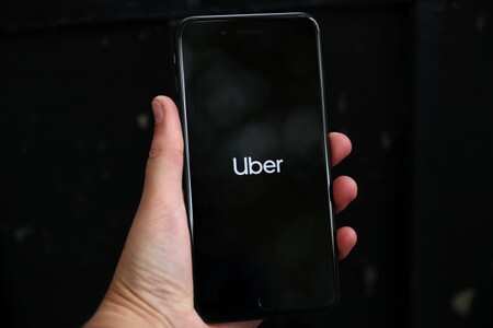 Uber's logo is displayed on a mobile phone in London, Britain, September 14, 2018. REUTERS/Hannah Mckay/File Photo