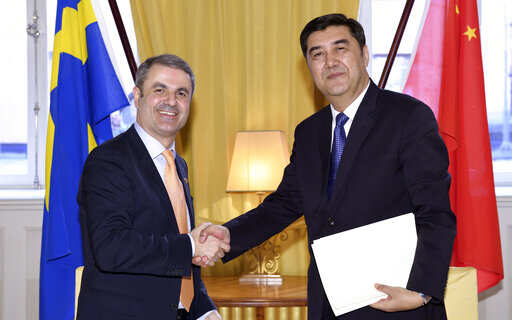 In this March 23, 2017 file photo, China's Energy Minister Nur Bekri, right, shakes hands with Sweden's Minister for Energy Ibrahim Baylan at the Swedish Government headquarters Rosenbad in Stockholm. 