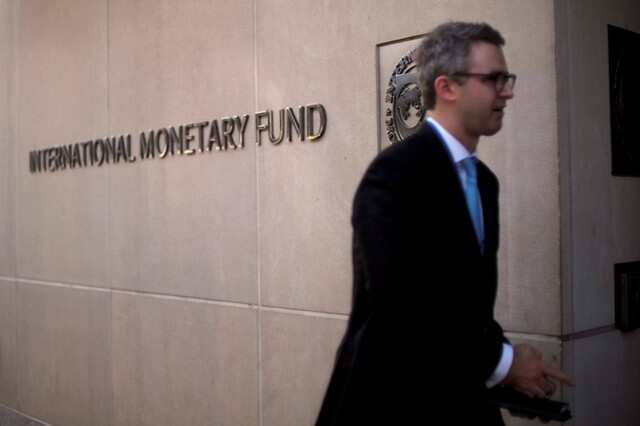 A man walks into IMF HQ. REUTERS/James Lawler Duggan