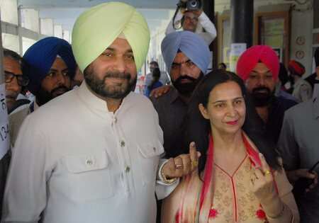 Punjab minister and Congress leaders Navjot Singh Sidhu with his wife Navjot Kaur Sidhu after casting their votes during the seventh and final phase of Lok Sabha elections, at a polling station in Amritsar.Photo)(