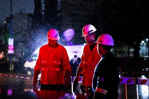 Technicians of Edenor electricity company stand under the rain as they work to fix a generator during a blackout in Buenos Aires, Argentina, Sunday, June 16, 2019. Photo/Tomas F. Cuesta)