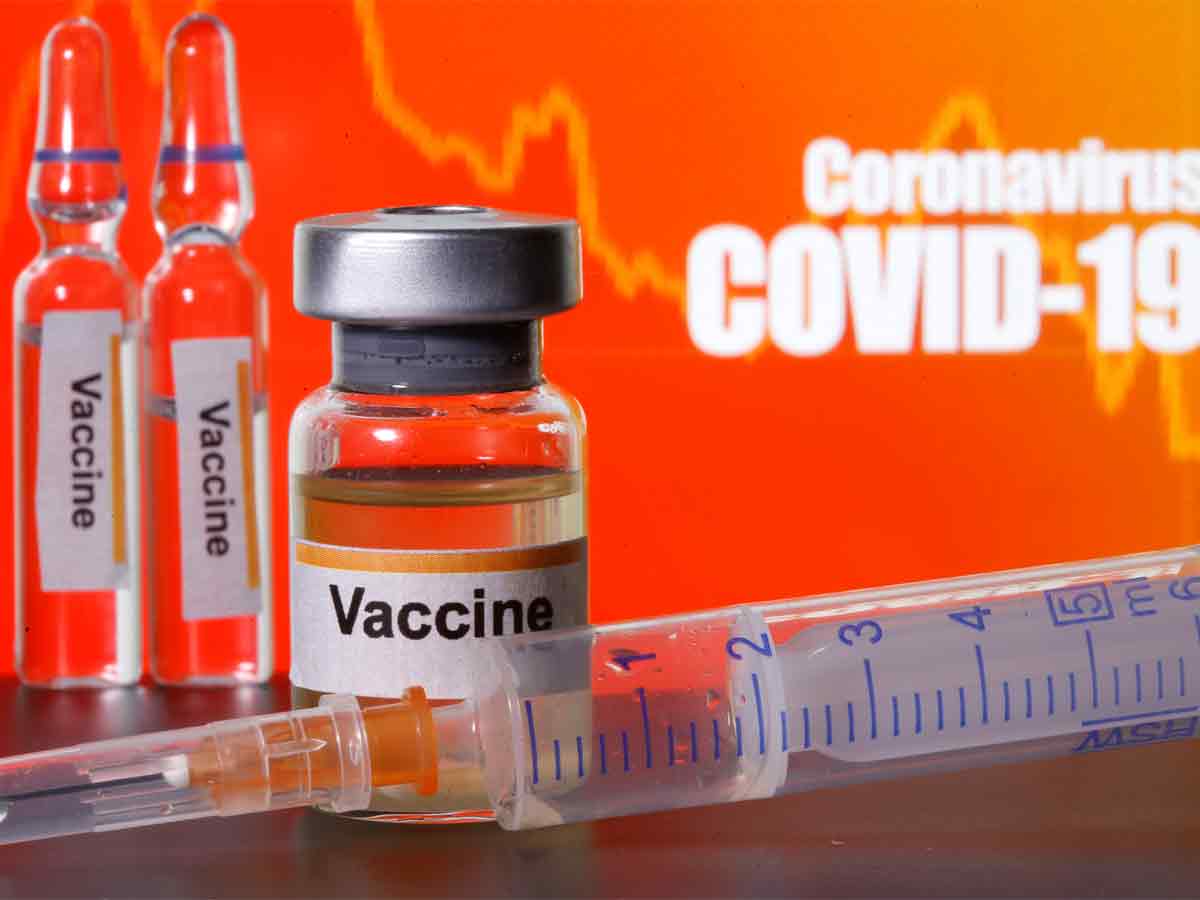 Small bottles labeled with 'Vaccine' stickers stand near a medical syringe in front of displayed 'Coronavirus COVID-19' words in this illustration taken. (Reuters Photo, used for representational purpose) 