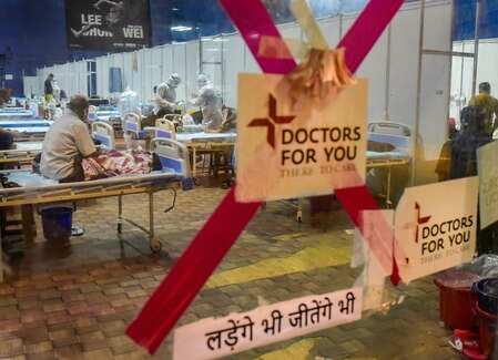 A team of doctors check patients at CWG village COVID-19 Care Centre, near Akshardham in New Delhi.Photo/Manvender Vashist)(