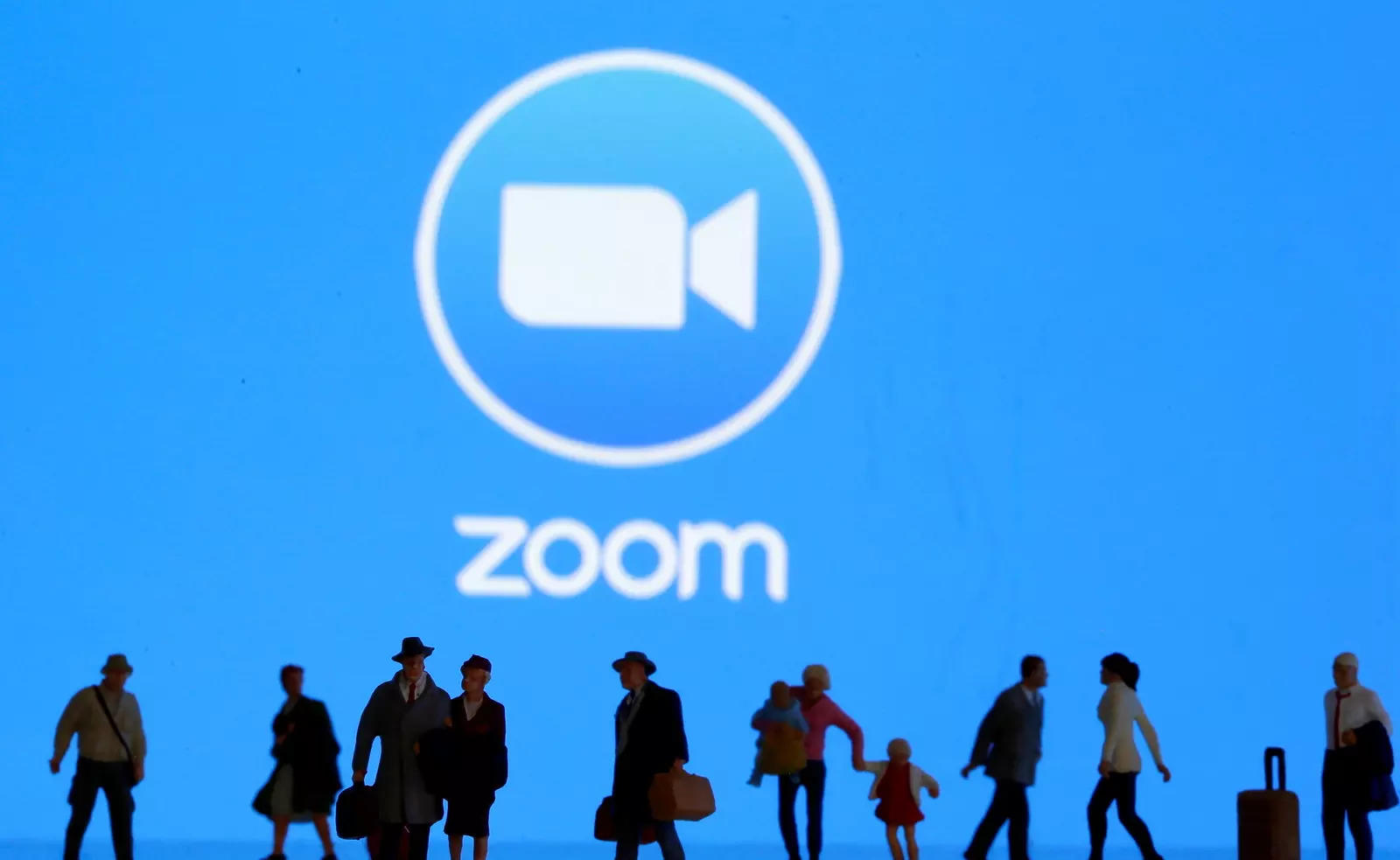 Small toy figures are seen in front of diplayed Zoom logo in this illustration taken March 19, 2020. REUTERS/Dado Ruvic/Illustration/File Photo