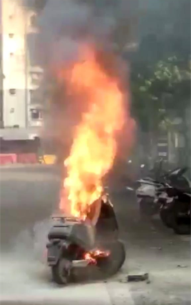 In the nearly three minute long video, plumes of smoke can be seen billowing out of the parked scooter initially before it is engulfed in fire.