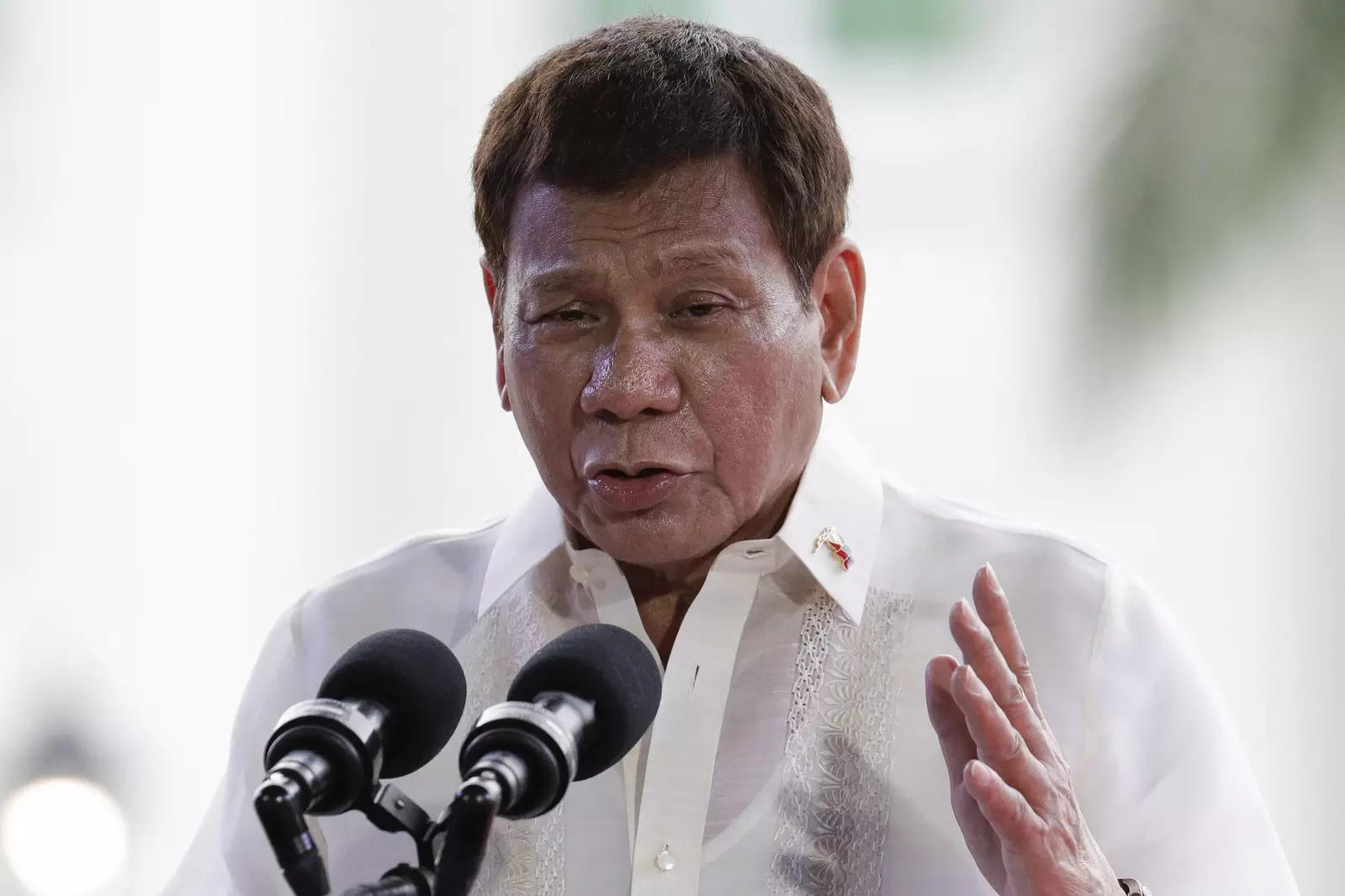   FILE - Philippine President Rodrigo Duterte gestures during a speech at the anniversary of the proclamation of the Philippine independence rites on Saturday, June 12, 2021, at the Provincial Capitol of Bulacan province, Philippines.  Duterte has gone on quarantine after being exposed to a member of his household staff infected with the coronavirus but he has twice tested negative for the virus after exposure over the weekend, his said Thursday, Feb.  4, 2022. (AP Photo/Aaron Favila)